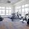 a gym with treadmills and windows