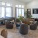 a large lounge room with a large window and various seating