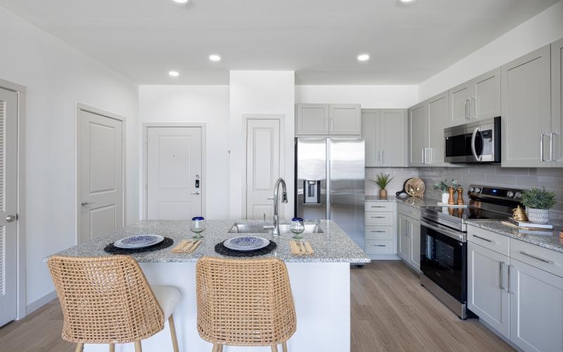 a kitchen with white cabinets and a kitchen island
