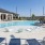 a swimming pool outside a building with lounge chairs