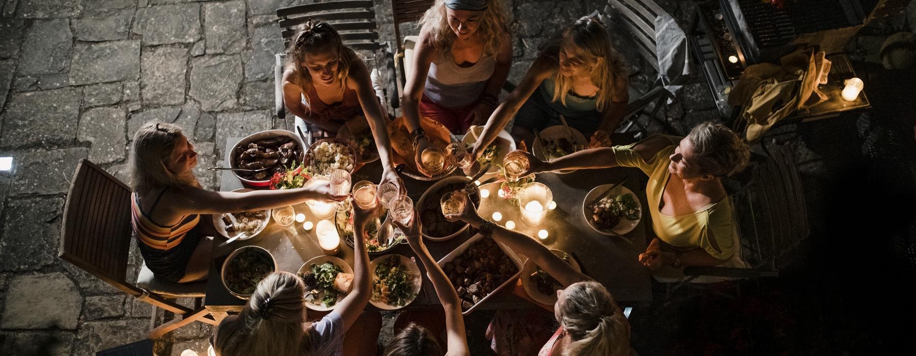 a group of people around a table full of food